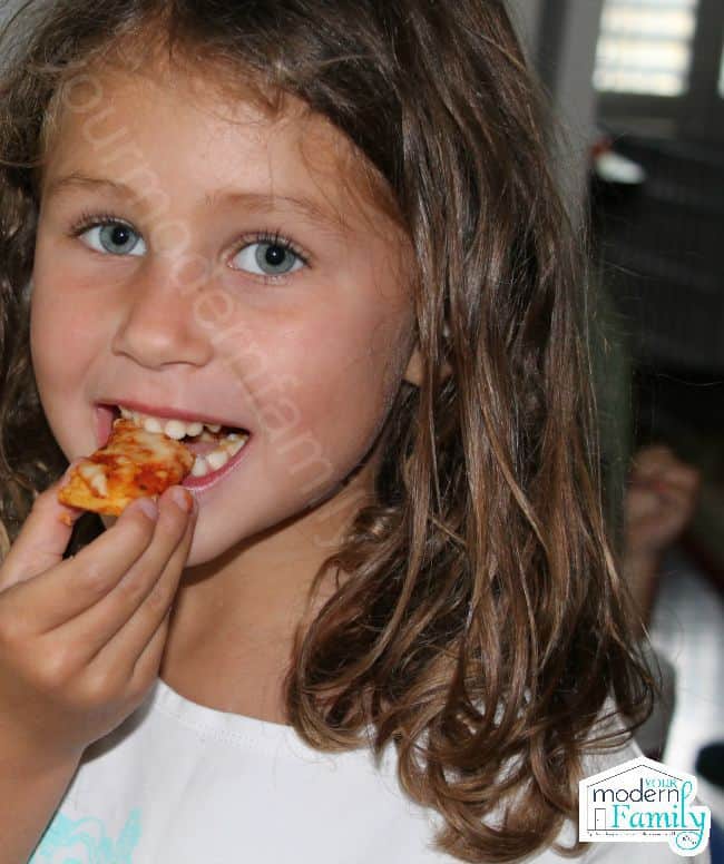A person eating a slice of pizza.