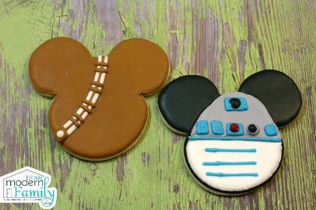 Two cookies shaped and decorated like Star Wars Mickey Mouse.