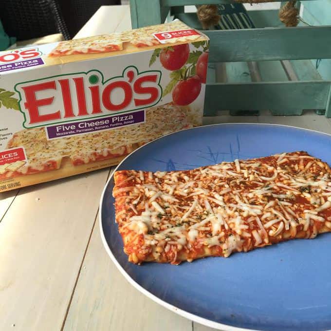 A box of Ellio\'s pizza and a prepared pizza on a blue plate.