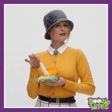 A woman hold a pack of Boogie Wipes and pulling one wipe out of the pack.
