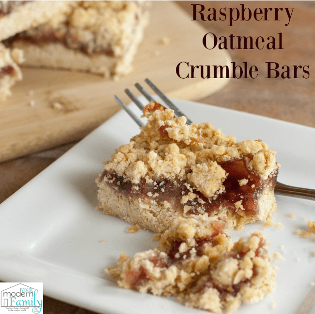 A piece of Raspberry Oatmeal bar with crumble topping on a white plate.