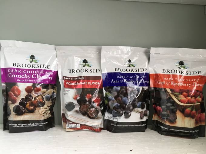 A variety of different flavors of Brookside candies in their bags.