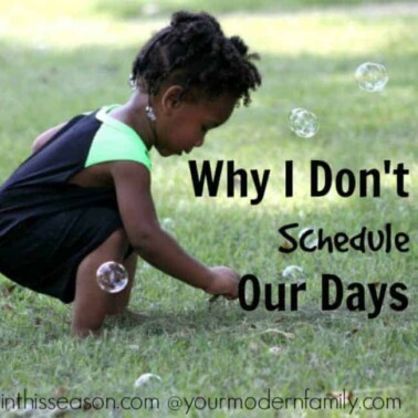 A child playing with bubbles in the grass with text beside her.