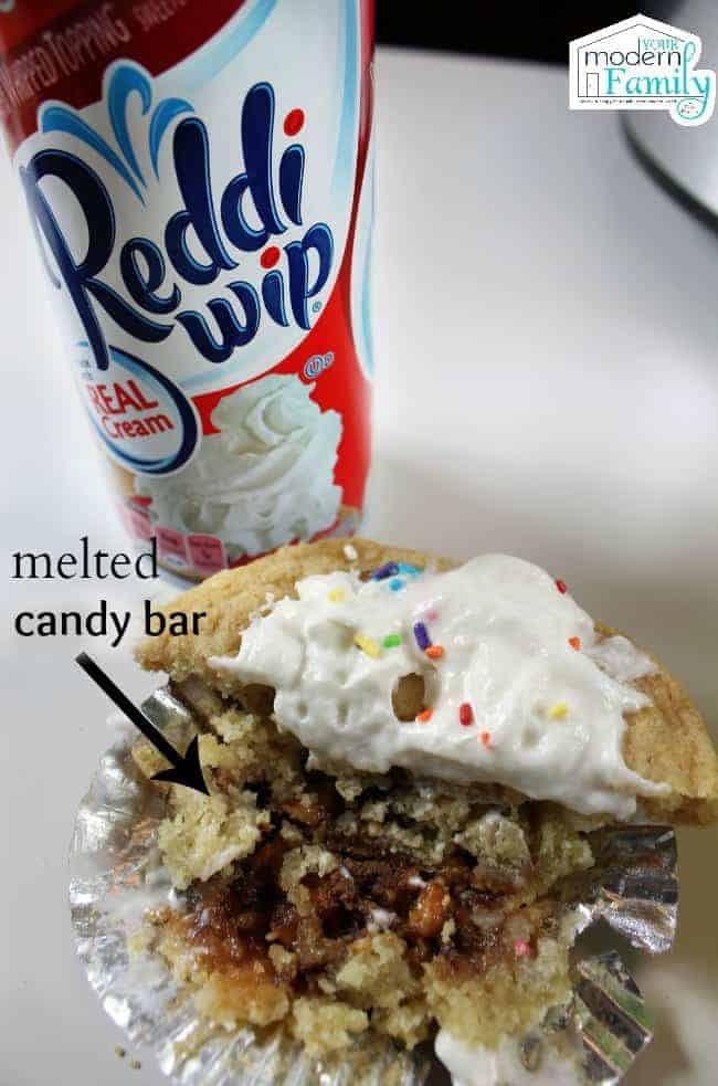 A cookie cake with a can of Reddi Wip behind it.