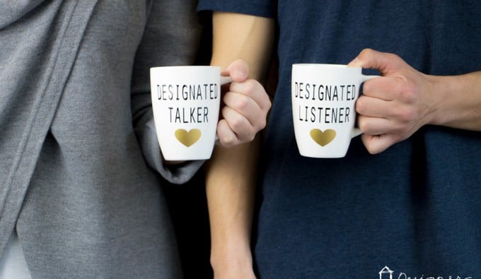 Two people holding cups of coffee with text on them.