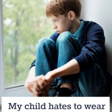 A young boy sitting with his arms wrapped around his knees looking out a window with text below him.