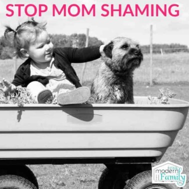 A little girl and a dog sitting in a wagon with text above them.