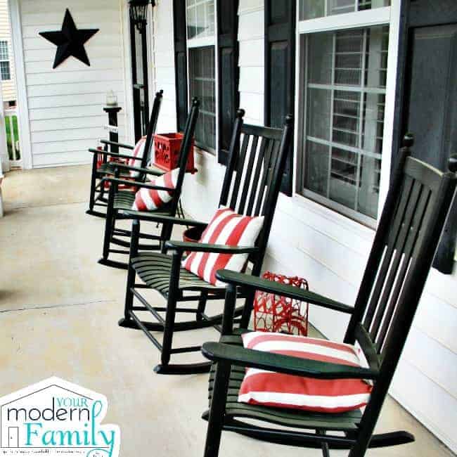 A row of rocking chairs on a front porch.