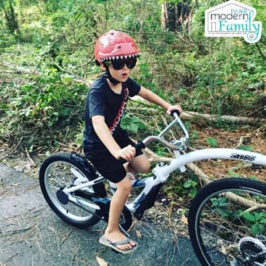 A young boy riding on a bike.