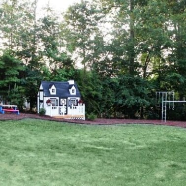 A playhouse in a back yard.
