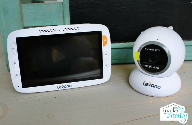 A baby monitor and video screen sitting on a counter.