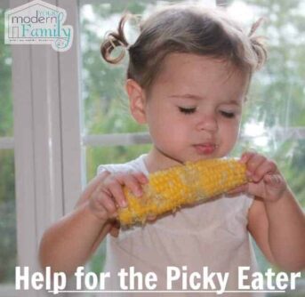 A young girl eating an ear of corn on the cob with text below her.