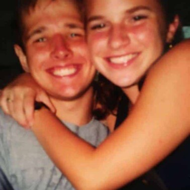 A couple smiling and posing for the camera.