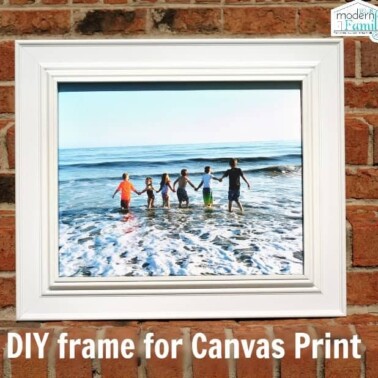 A framed canvas print of children on the beach with text below it.
