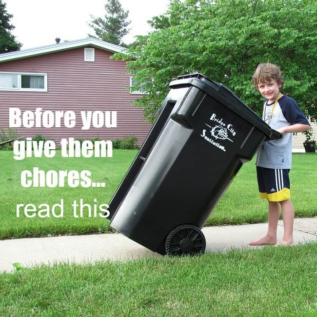 A boy pulling a large garbage can on a sidewalk with text beside him.