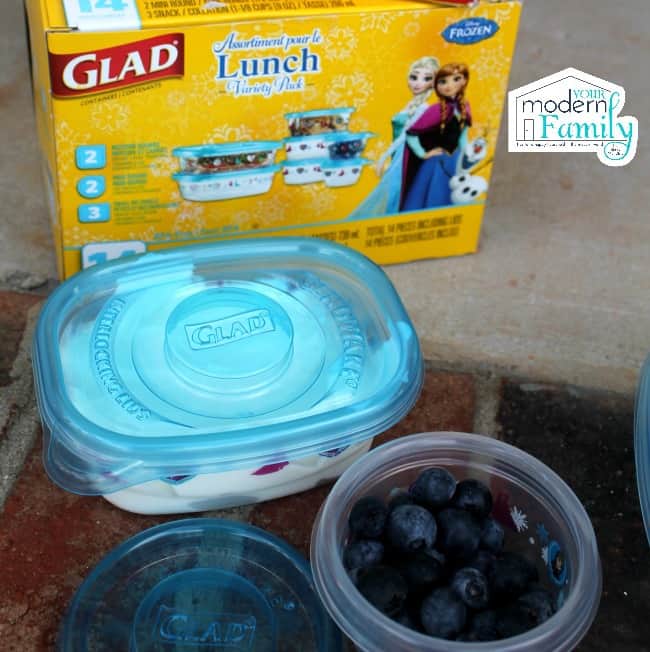Plastic containers filled with food with a box of Glad lunch containers behind them.