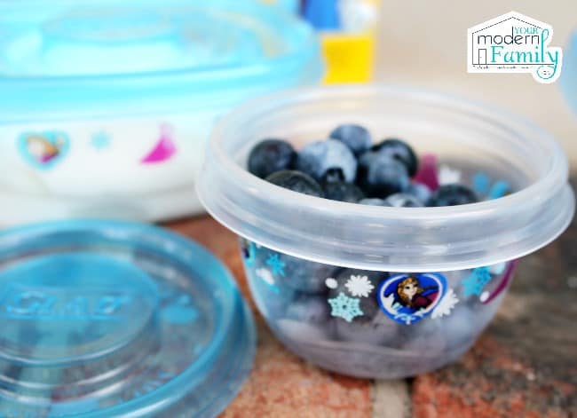 A Glad container with blueberries in it.