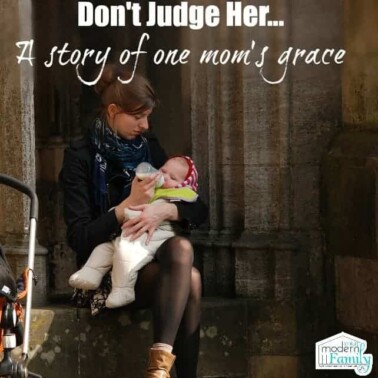 A person sitting on steps feeding a baby with text above them.