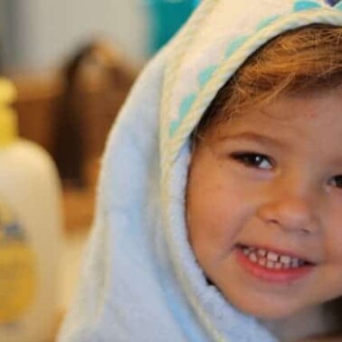 A little girl smiling at the camera.