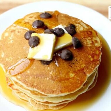 Stack of  Pancakes with blueberries, butter and syrup.