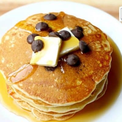 Stack of  Pancakes with blueberries, butter and syrup.