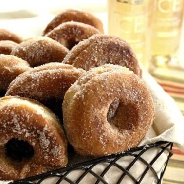 A basket of doughnuts sitting on a table.