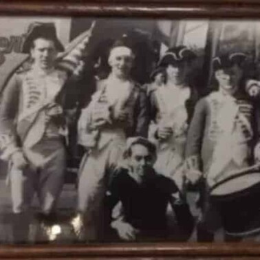 A group of people in uniforms posing for a photo.