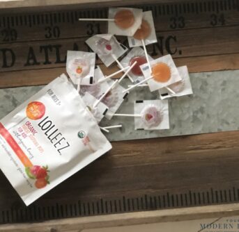A wooden cutting board with Lolleez sore throat lollipops.