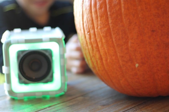 A close up of Bose speaker with a pumpkin beside it.