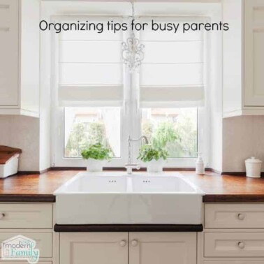 A kitchen with a sink and a window with text above it.