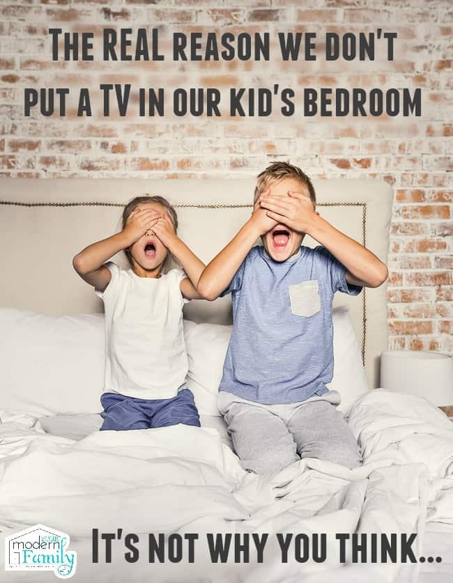 Two children kneeling on a bed with their hands covering their eyes and their mouths open.