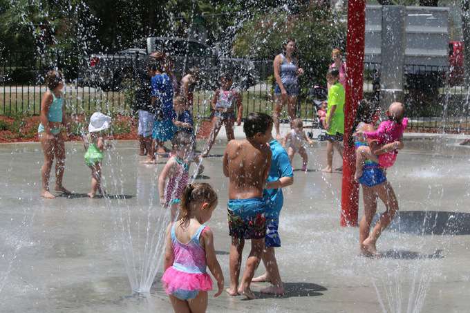 A group of kids playing at a water park.