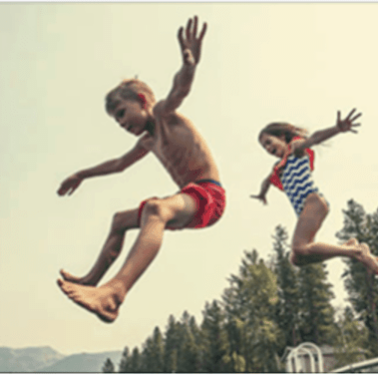 Two kids jumping in the air.