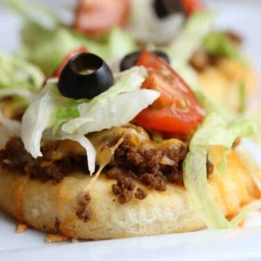 A close up of a plate of food with  Taco Pizza.