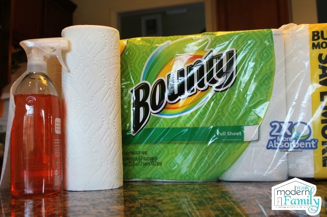  A package of Bounty paper towels with a spay bottle of cleaner beside it.