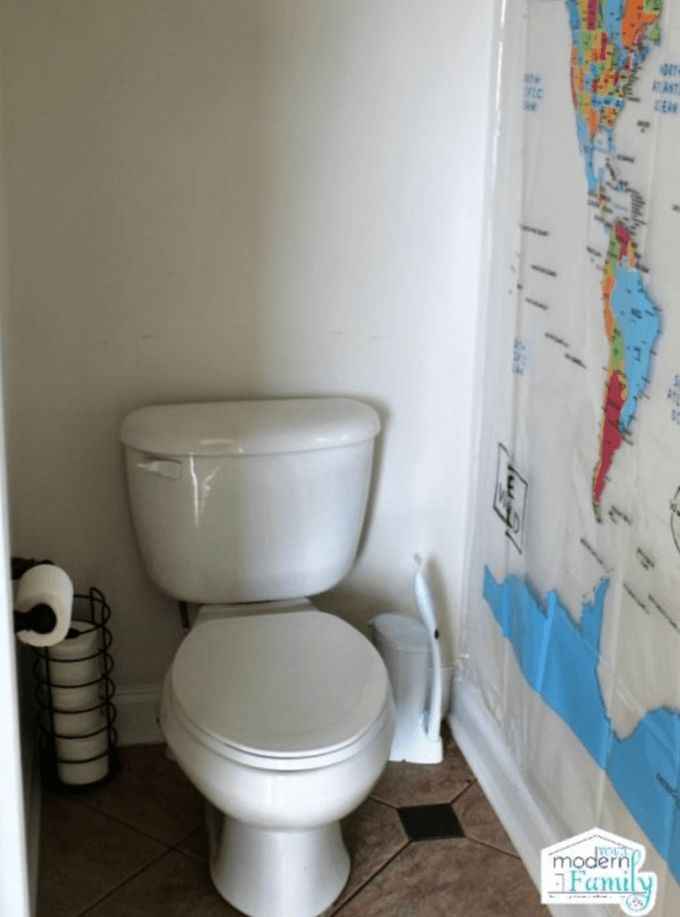 A close up of a bathroom with a white toilet.