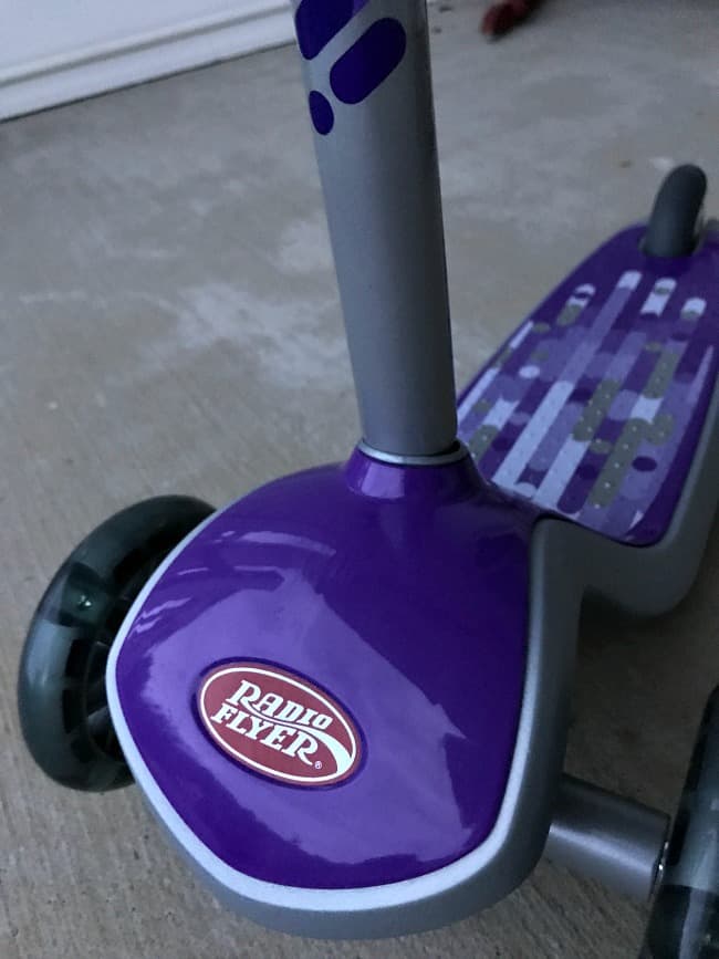 A close up of a purple Radio Flyer  scooter.