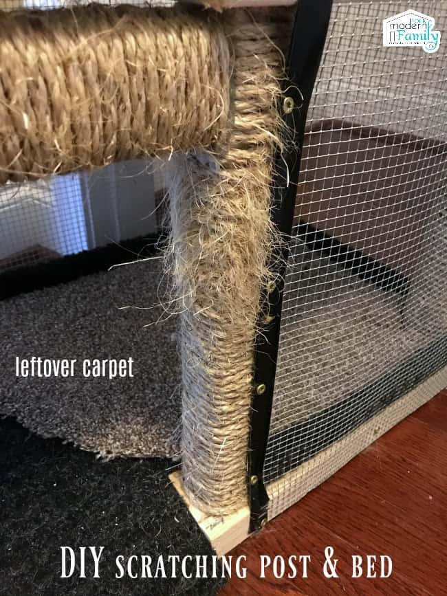 A close up of a home made cat scratching post and bed.