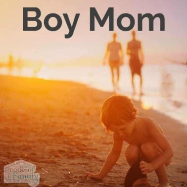 A little boy playing on a beach with a couple walking behind him.