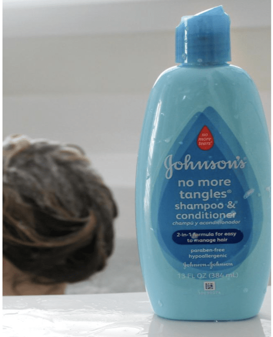 A close up of a bottle of Johnson\'s shampoo and conditioner.