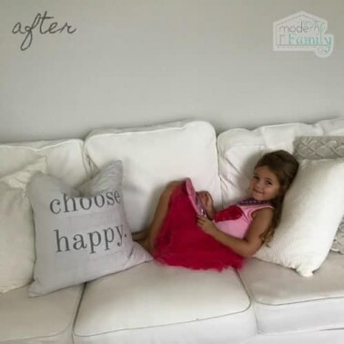 A girl lying on a white couch.