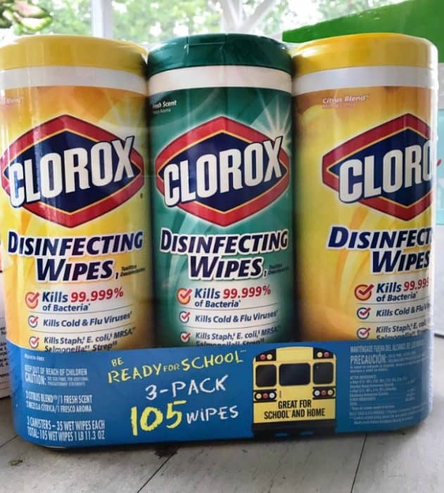 A three pack of Clorox wipes sitting on the table.