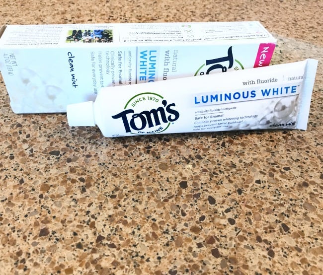 A tube and box of Tom\'s tooth paste lying on the counter.