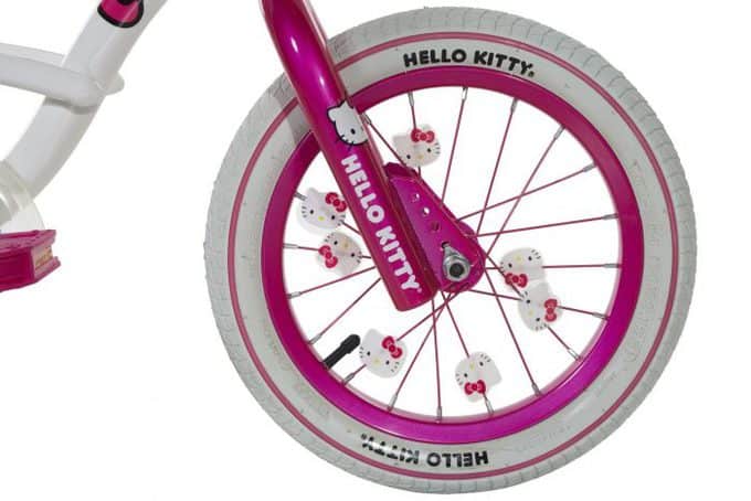 A close up of a Hello Kitty bicycle wheel.