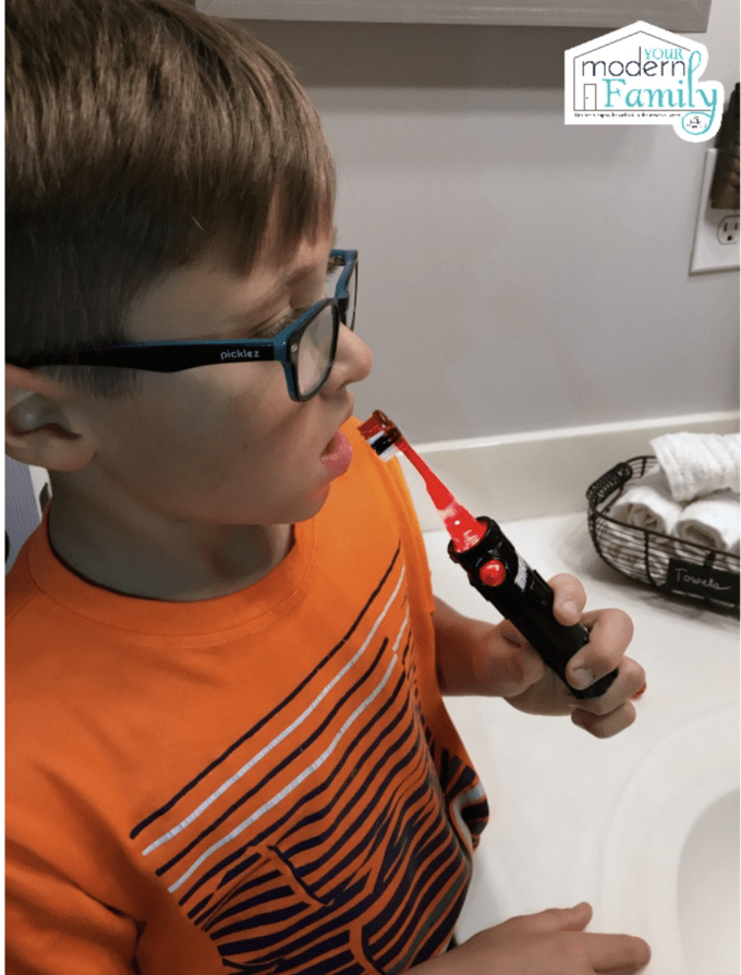A boy brushing his teeth.