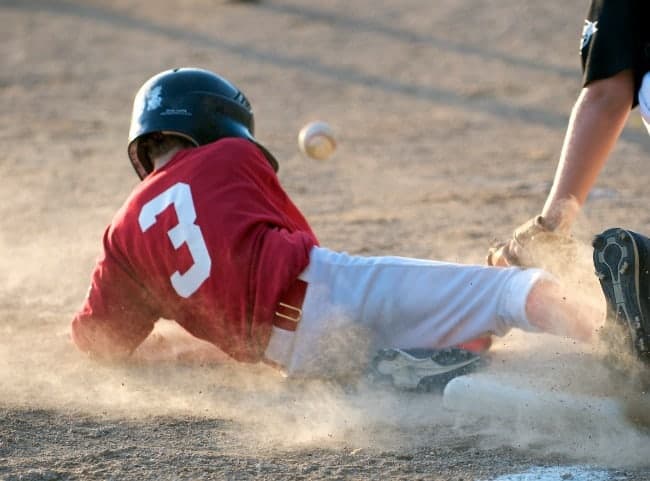 A baseball player sliding into a base.