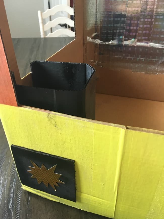 A close up of a cardboard box painted yellow.