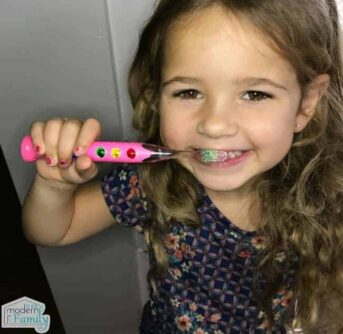 A little girl brushing her teeth.