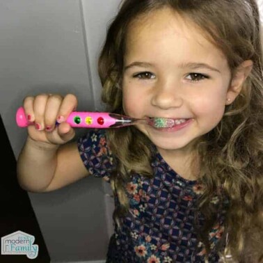 A little girl brushing her teeth.