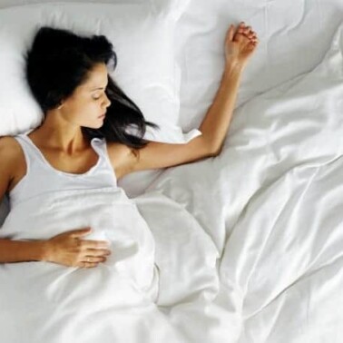 A woman lying on a bed.